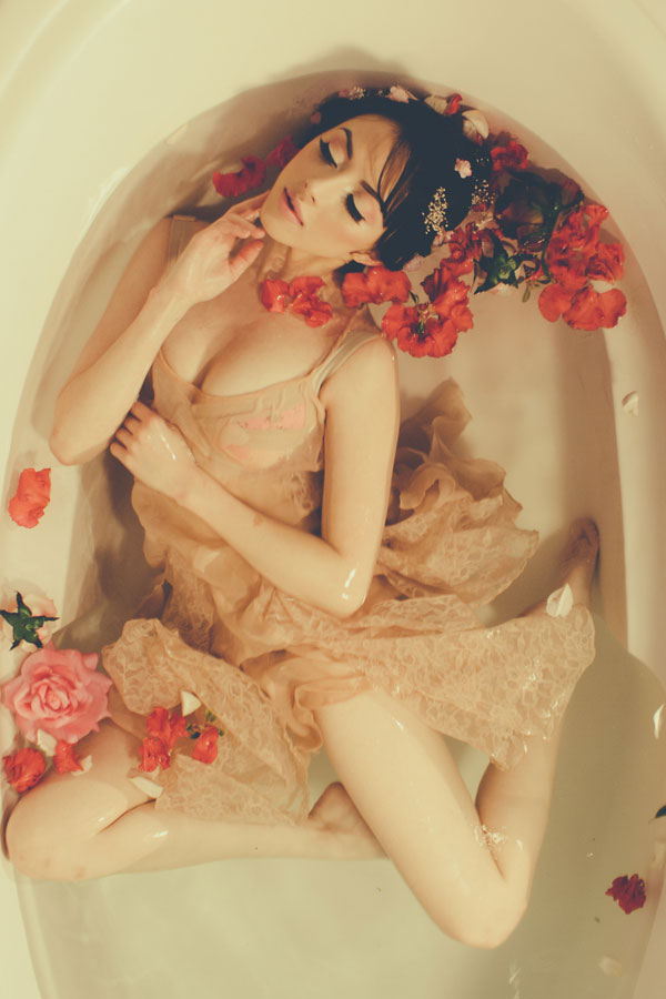 Enchanting Bathtub Boudoir Session Surrounded By Free Flowing Fabric & Rosey Blooms